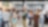 A lively office social event with diverse people conversing and drinking coffee.