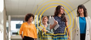 Four people walk confidently in a modern