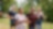 Four people jog in a park, all smiling and energetic