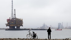 Passers-by stop to watch