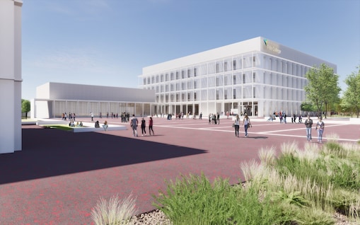 Woman examining a wind turbine model in class