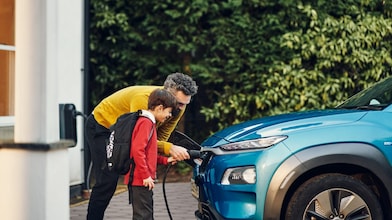 father and son with ev charger