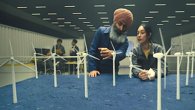 man pointing at wind turbine
