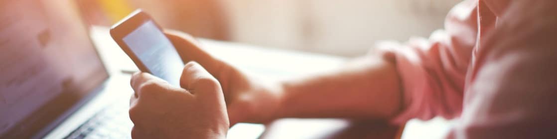 Man with phone and laptop