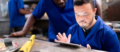 Colleagues using digital tablet and working in industry