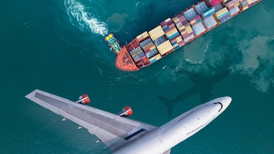 Aerial view of a plane flying past a cargo ship that was leaving the harbour, with a truck boat spinning a large ship.