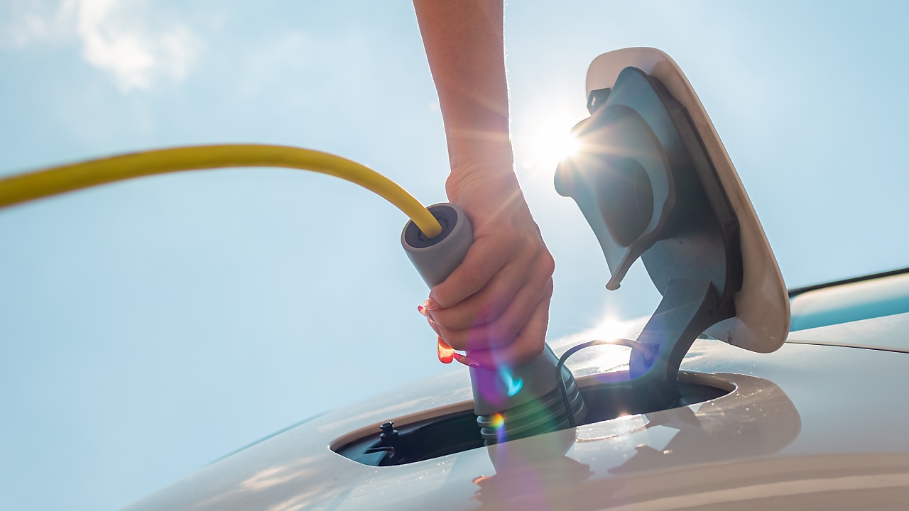 Hand charging electric car with charger cable