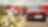 A family of three approach their red electric car after a day out together