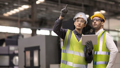 Two engineers in hard hats assessing