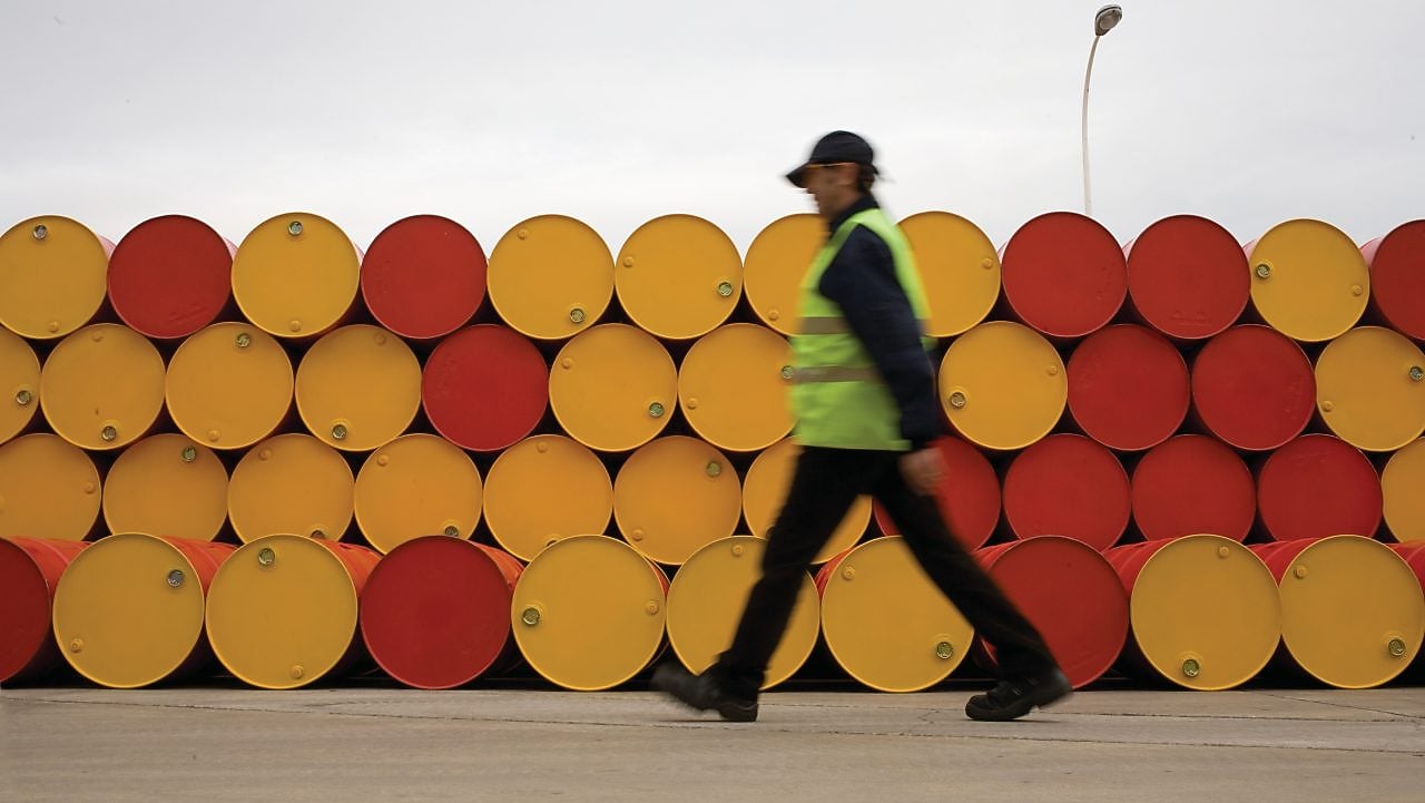 man walking barrels lubricants