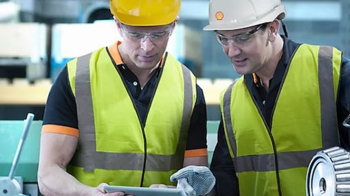 Two construction workers in hard hats and high vis jackers