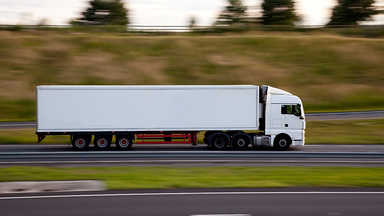 Lorry on motorway Blurred motion truck seen driving on road.