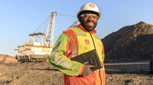 Shell engineer carrying documents across a mine