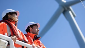 Wind technician standing outside of wind turbine