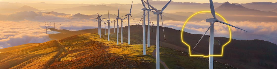 Businessman in office looking at models of wind turbines