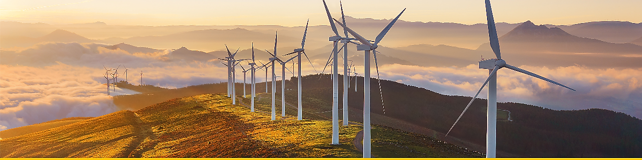 Businessman in office looking at models of wind turbines