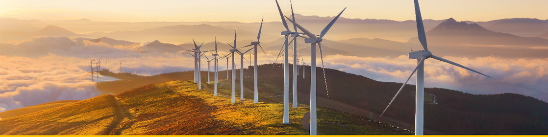 Businessman in office looking at models of wind turbines