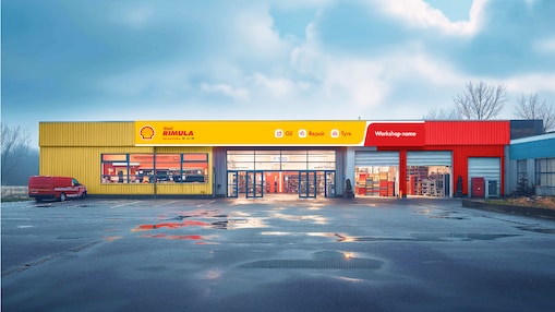 A view of a Shell-branded truck workshop. The building has a yellow and red facade with the Shell logo and 'Shell Rimula' prominently displayed.