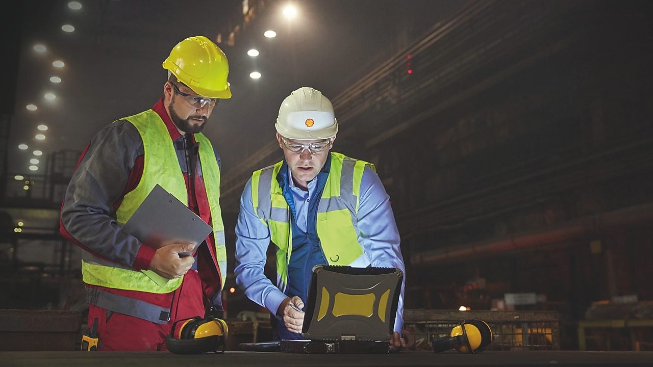 Two engineers looking at screen