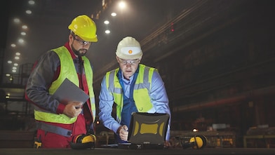 Two engineers looking at screen