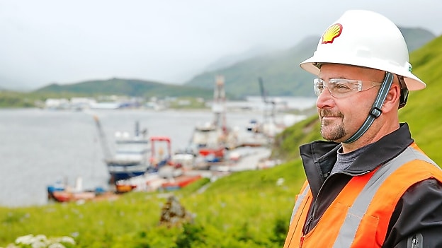 Shell engineer in hard hat smiling over river