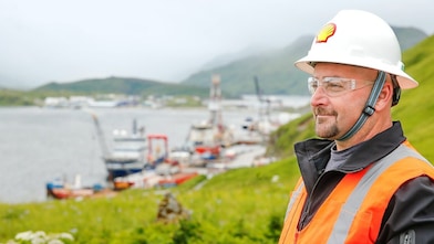 Shell engineer in hard hat smiling over river