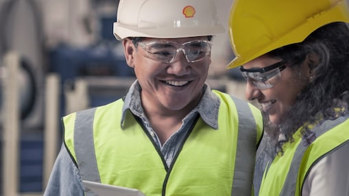 Two engineers inspecting a tablet