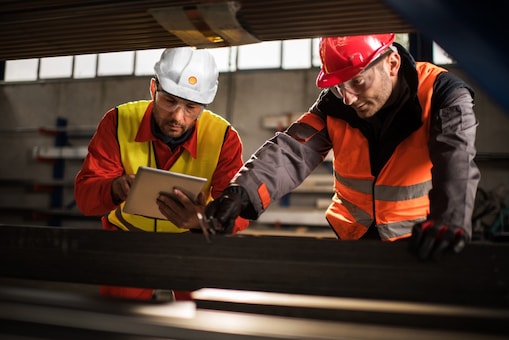 Two engineers inspecting a tablet