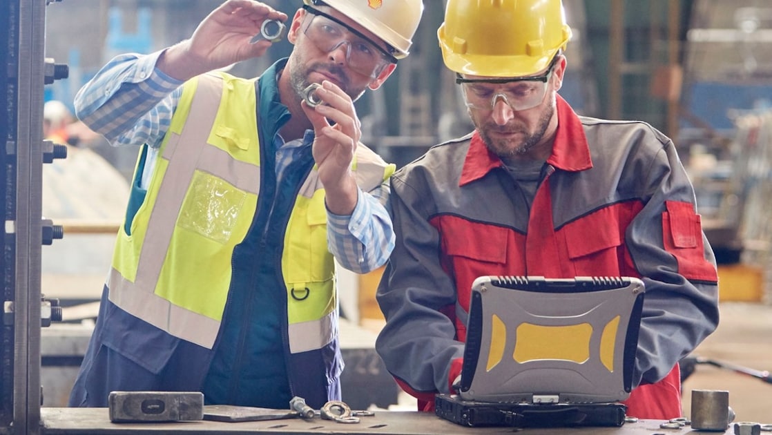Shell worker consulting an industry worker on site