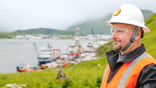 Shell engineer in hard hat smiling over river