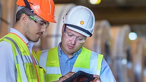 Two Shell engineers peering at tablet
