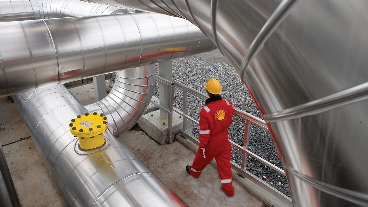 Employee walking along gas infrastructure