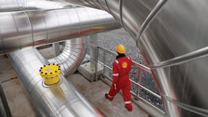 Employee walking along gas infrastructure