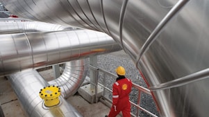 Employee walking along gas infrastructure