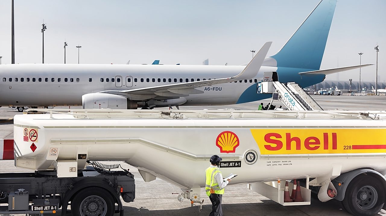Shell Aviation refuelling operations with Shell tanker truck in front of a plane.