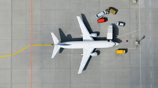 Arial view of the top of a passenger airplane on the tarmac being filled up with fuel