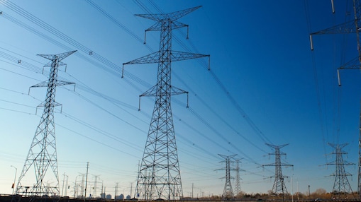 Electricity transmission network with high-voltage power lines delivering energy across the grid.
