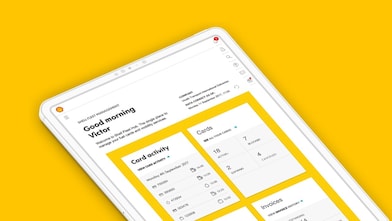 Angled view of a tablet on a yellow background displaying a dashboard interface with greeting text and card activity panels.