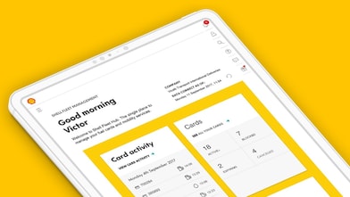 Angled view of a tablet on a yellow background displaying a dashboard interface with greeting text and card activity panels.