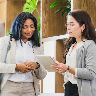 Two Women Smiling and Discussing