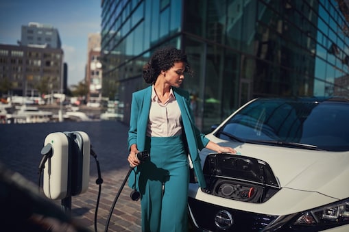 Woman at Shell Recharge charging station