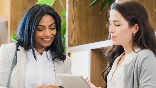 two women smiling and discusing 