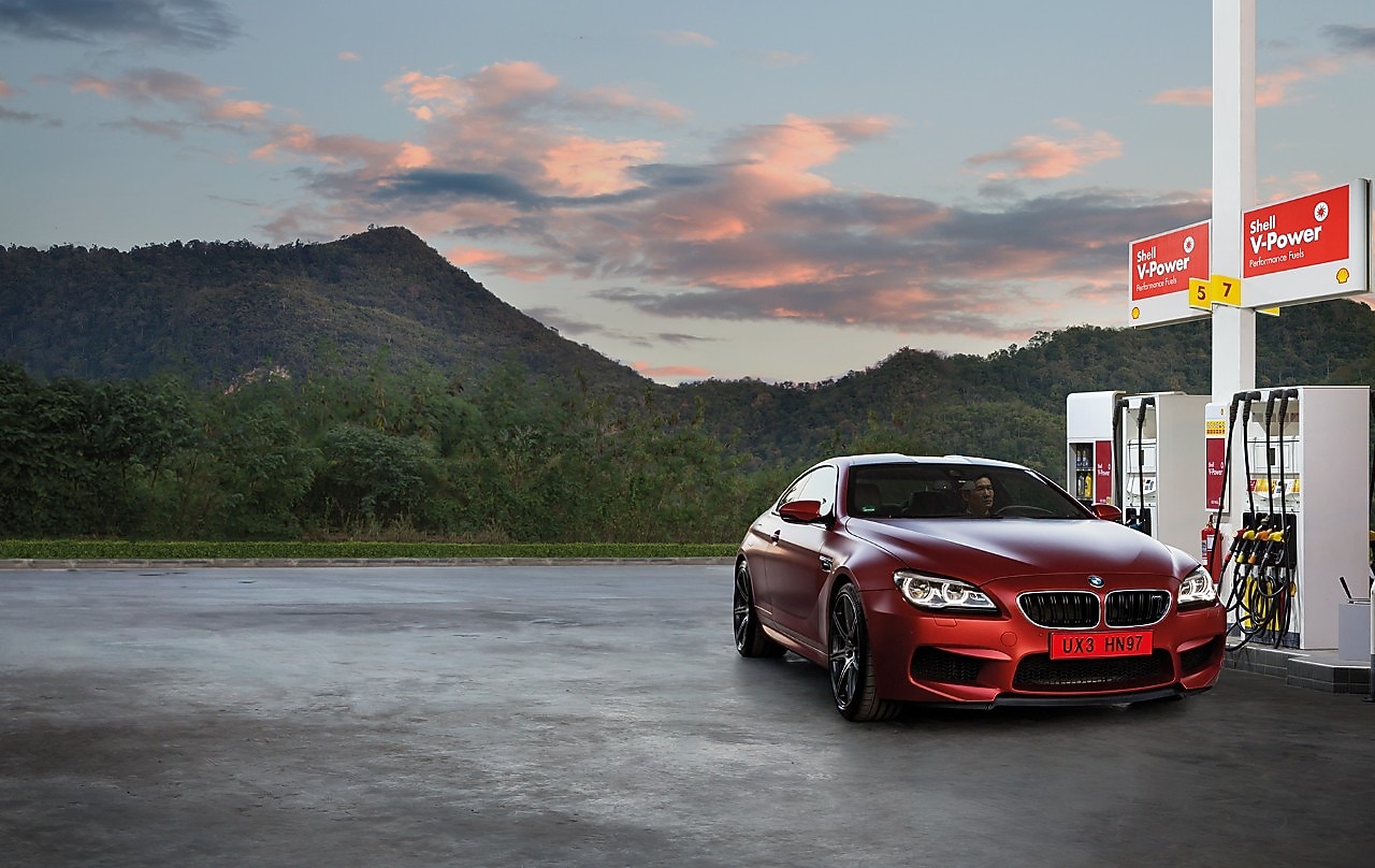 Red BMW in Shell forecourt at pumps