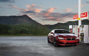 Red BMW in Shell forecourt at pumps