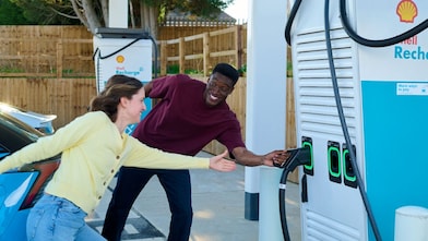 People at Shell Recharge electric vehicle charging station
