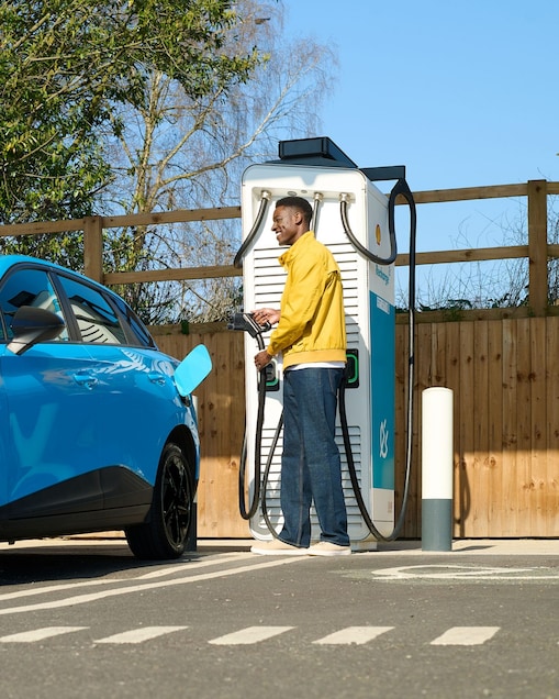 Man charging car at a Shell Recharge Station