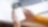 A person holding a phone, open on the Shell App