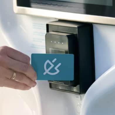 Charge card being tapped against Recharge machine