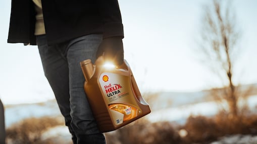 Man holding Shell Helix Ultra bottle