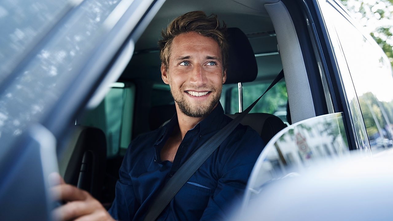 Man smiling in a car